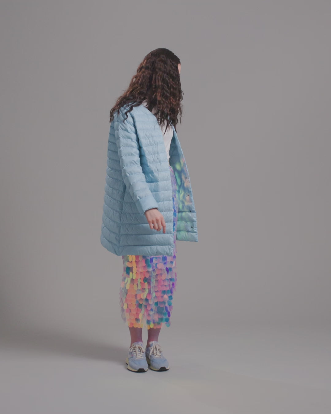 Nainen tanssii pukeutuneena vaaleansiniseen, auki olevaan polvipituiseen Vuokko-kevytuntuvatakkiin (väri: jääkaramelli), valkoiseen yläosaan ja näyttävään moniväriseen paljettihameeseen. Asuun kuuluu myös suuret rengaskorvakorut.