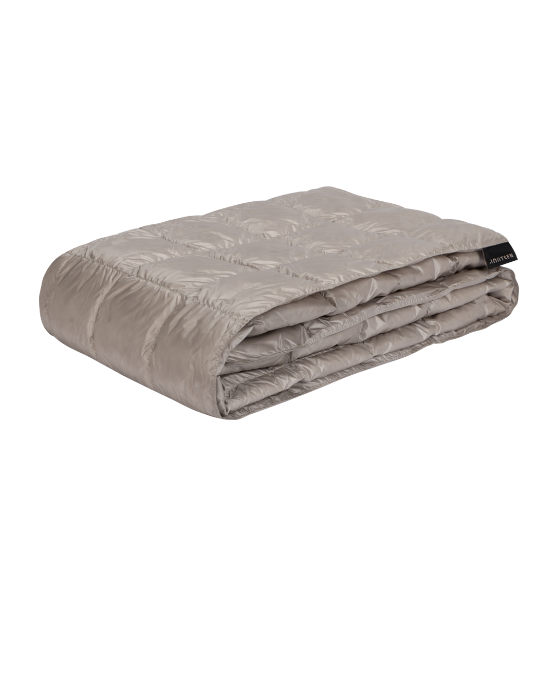 Beige Kulkuri-untuvatorkkupeitto on taiteltu siististi ja sen pintaa koristavat ommellut neliömäiset tikkauskuviot. 